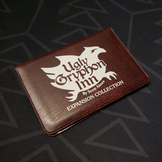 Image shows the front of the card wallet of the Expansion Collection for the card game Ugly Gryphon Inn
