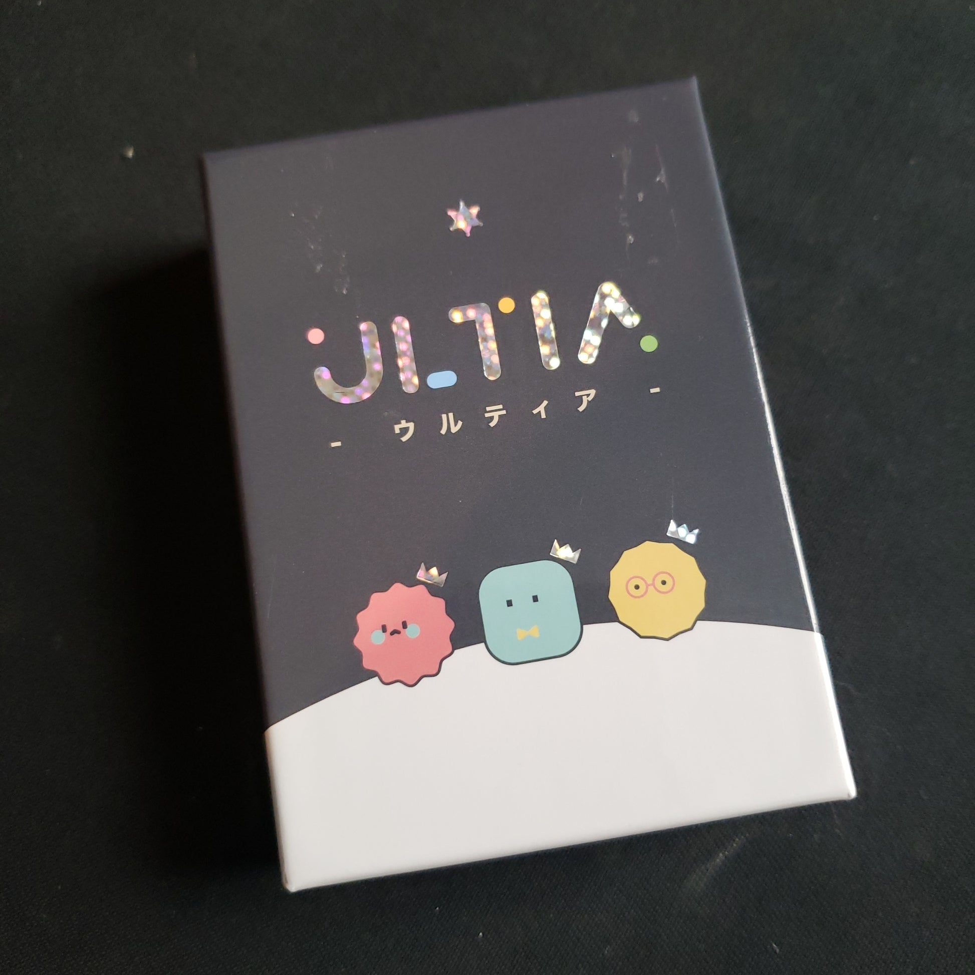 Image shows the front cover of the box of the Ultia card game