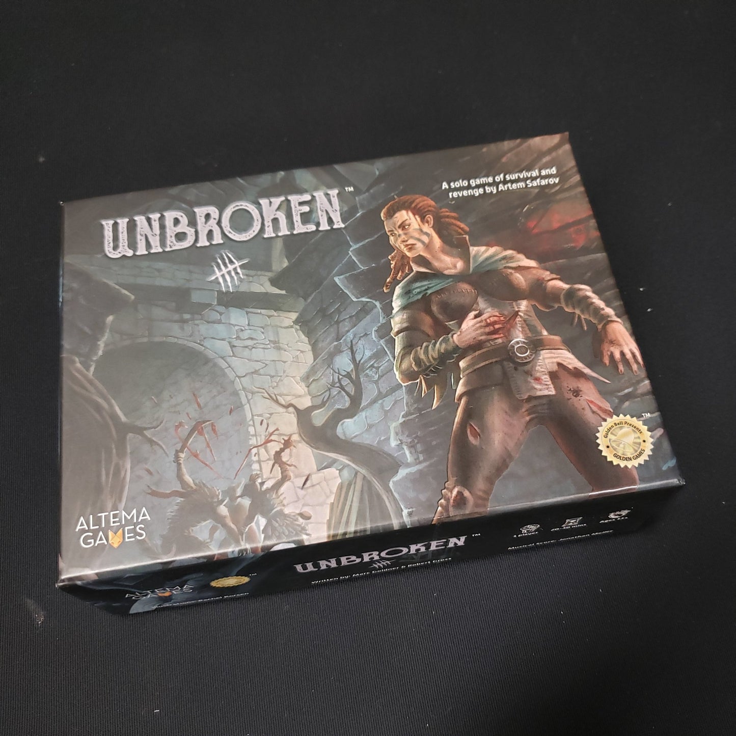 Image shows the front cover of the box of the Unbroken board game