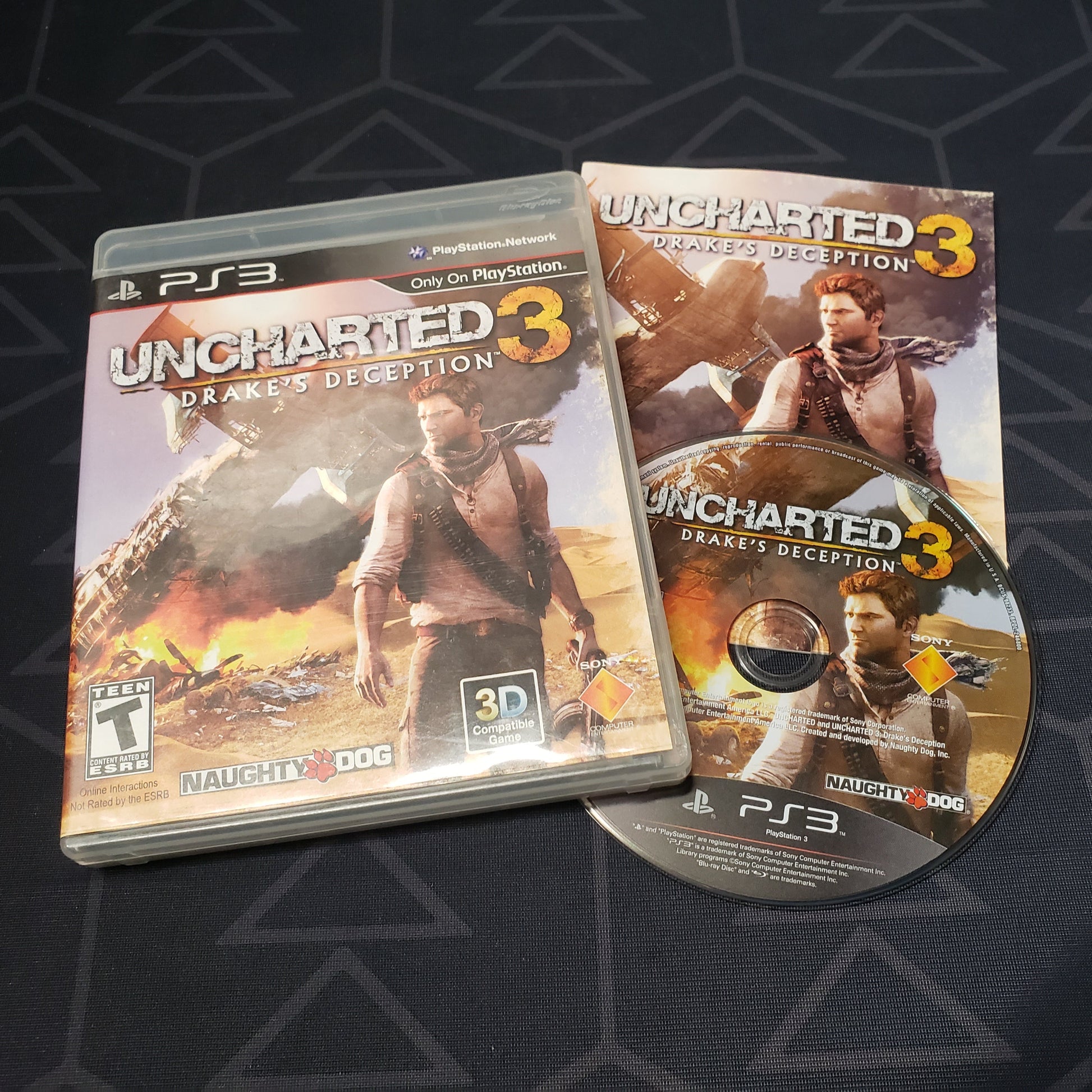 Image shows the case, manual and disc for the video game Uncharted 3: Drake's Deception for Playstation 3