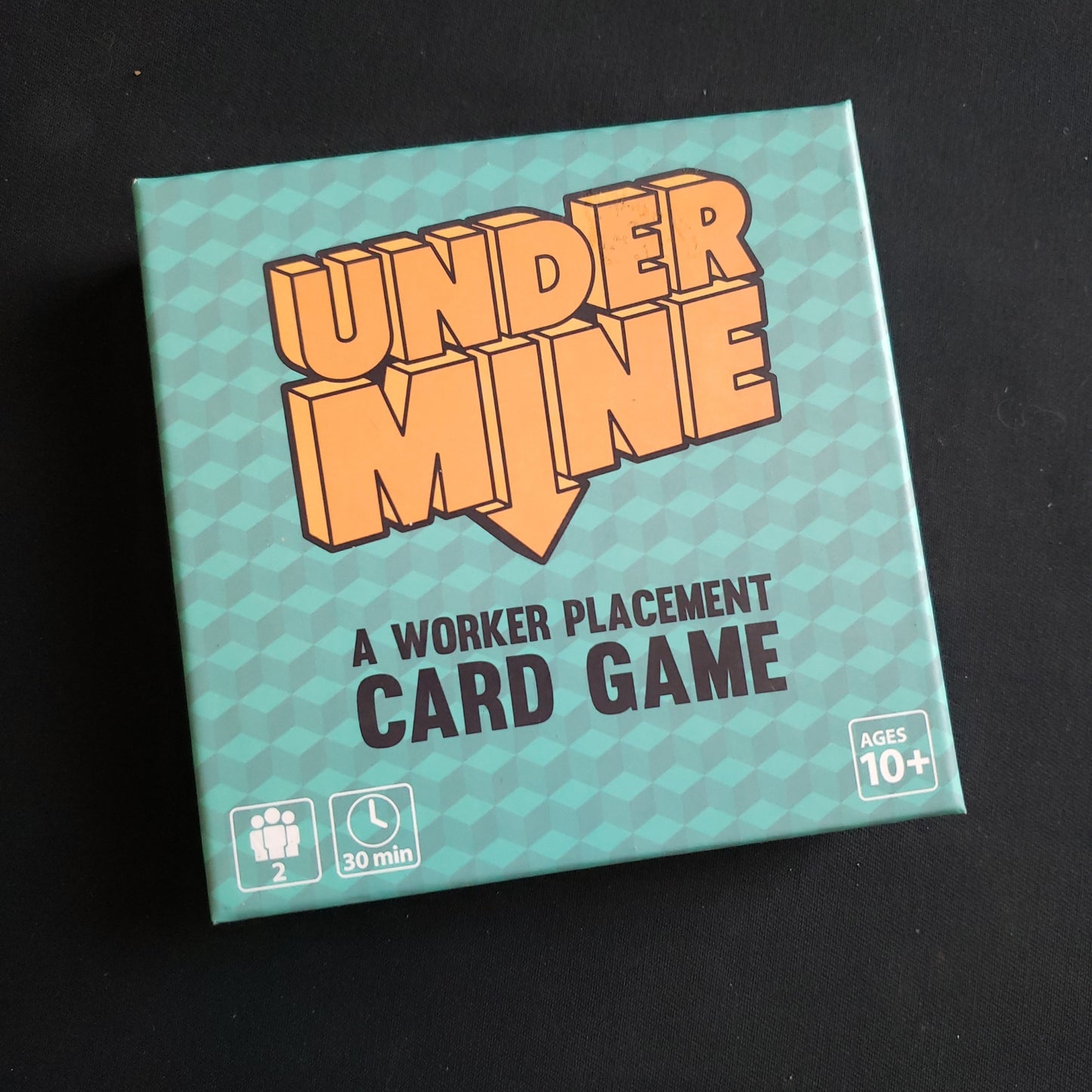 Image shows the front cover of the box of the Undermine card game