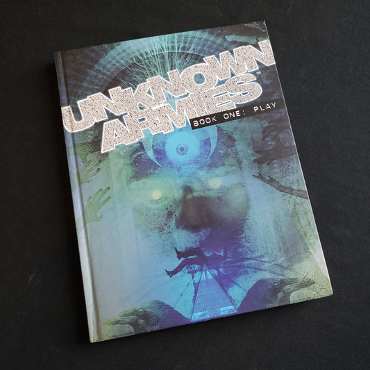 Image shows the front cover of the book "Book One: Play" for the Unknown Armies: Third Edition roleplaying game