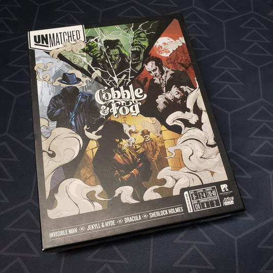 Image shows the front cover of the box for the Unmatched: Cobble & Fog board game