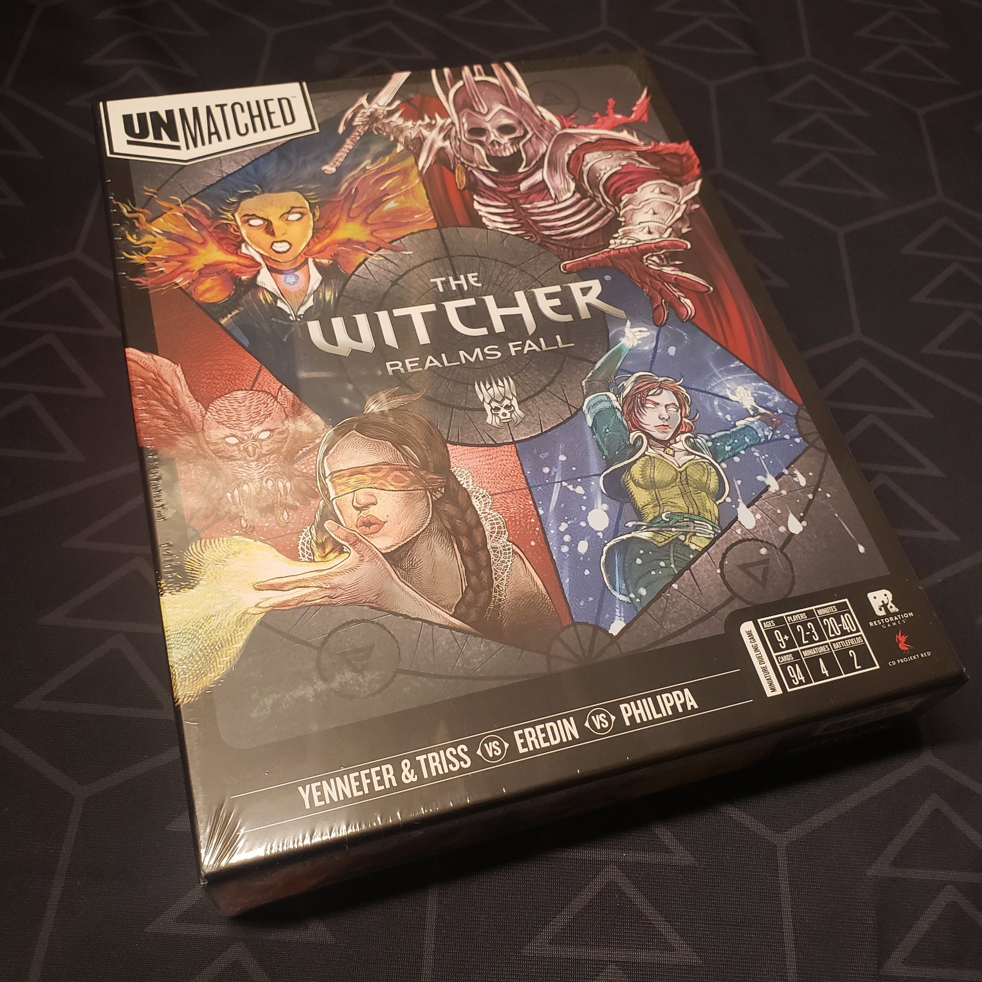 Image shows the front cover of the box for the Unmatched: The Witcher - Realms Fall board game