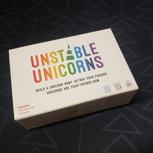 Image shows the front cover of the box of the Unstable Unicorns card game