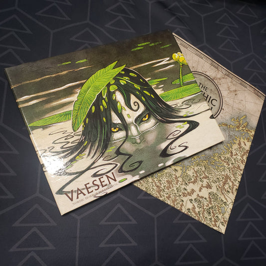Image shows the front panel of the GM Screen for the roleplaying game Vaesen, sitting on top of a map for the game