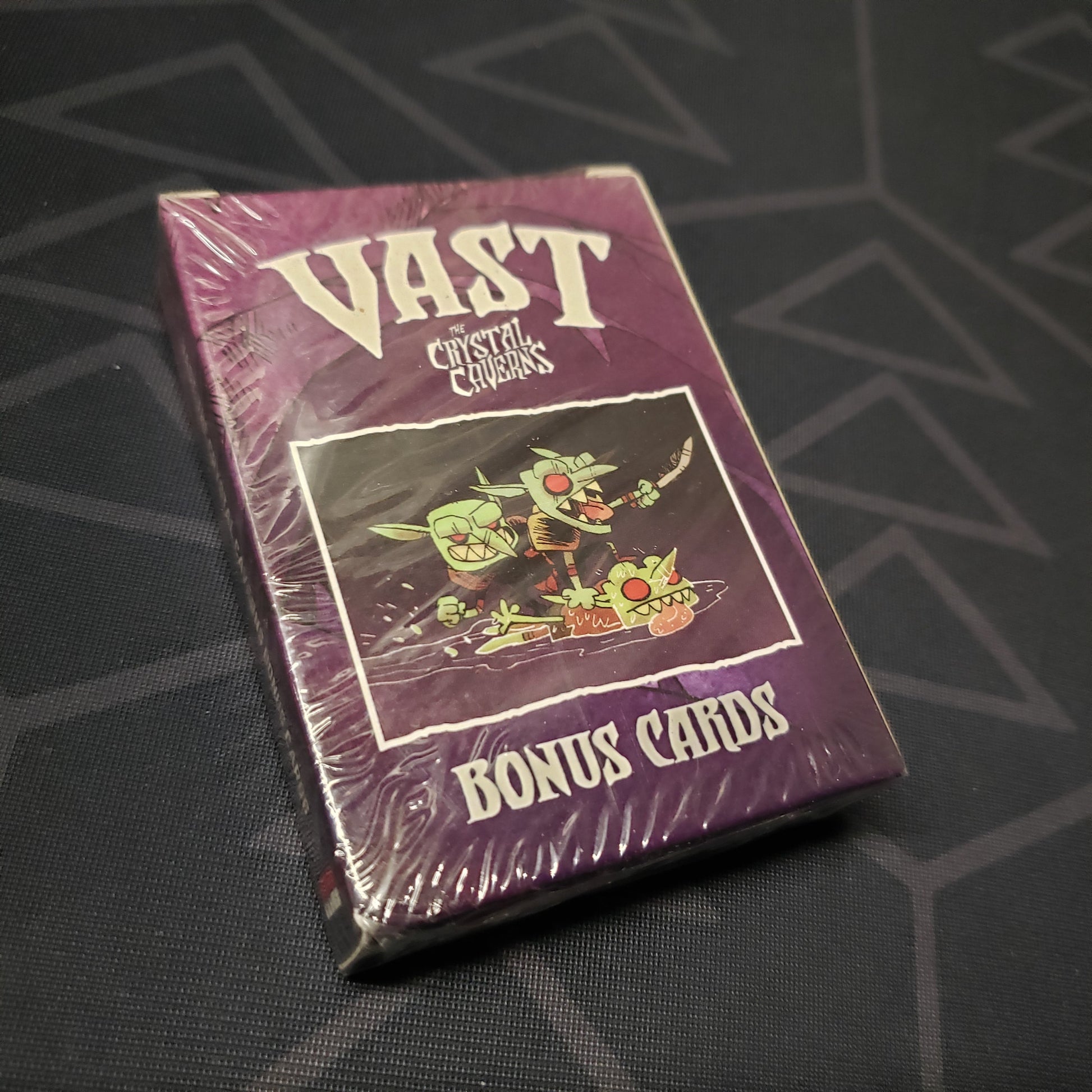 Image shows the front cover of the box of the Bonus Cards expansion for the board game Vast: The Crystal Caverns