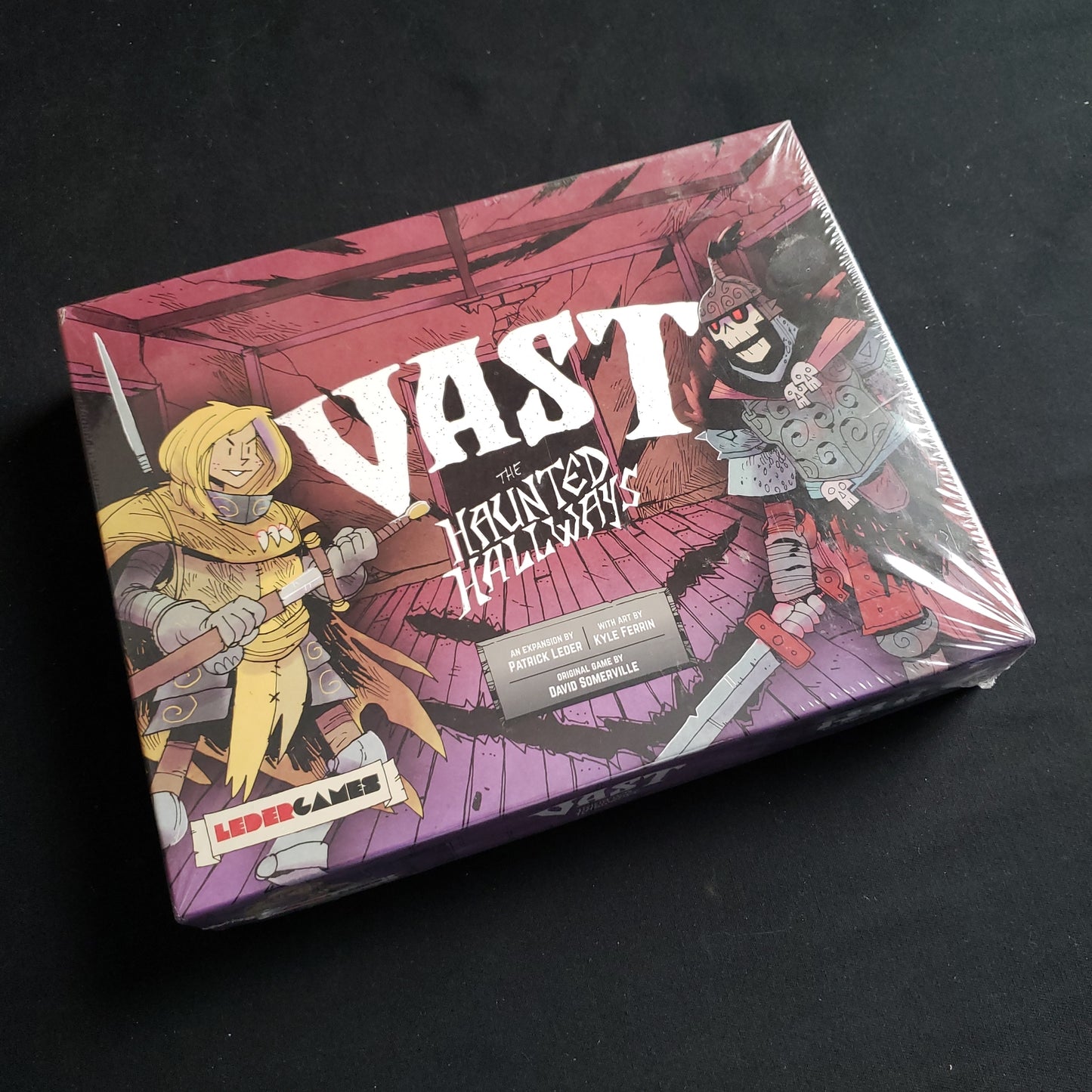 Image shows the front cover of the box of the Vast: Haunted Hallways expansion for the Vast: Mysterious Manor board game