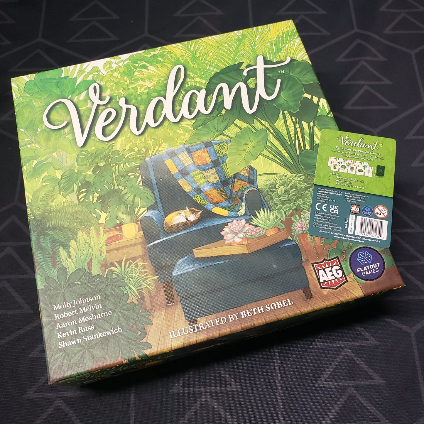 Image shows the front cover of the box of the Verdant board game with the info card for the Potless Plants mini expansion sitting on top of it