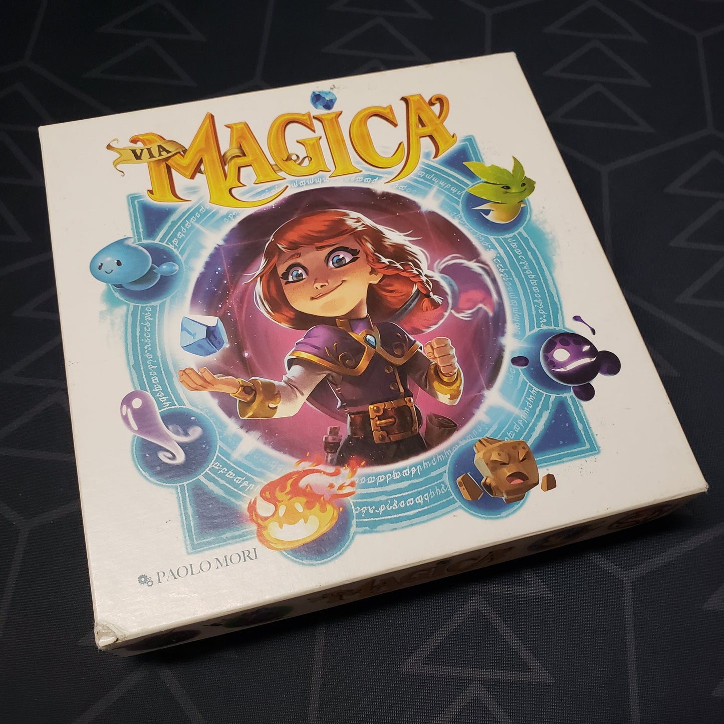 Image shows the front cover of the box for the Via Magica board game