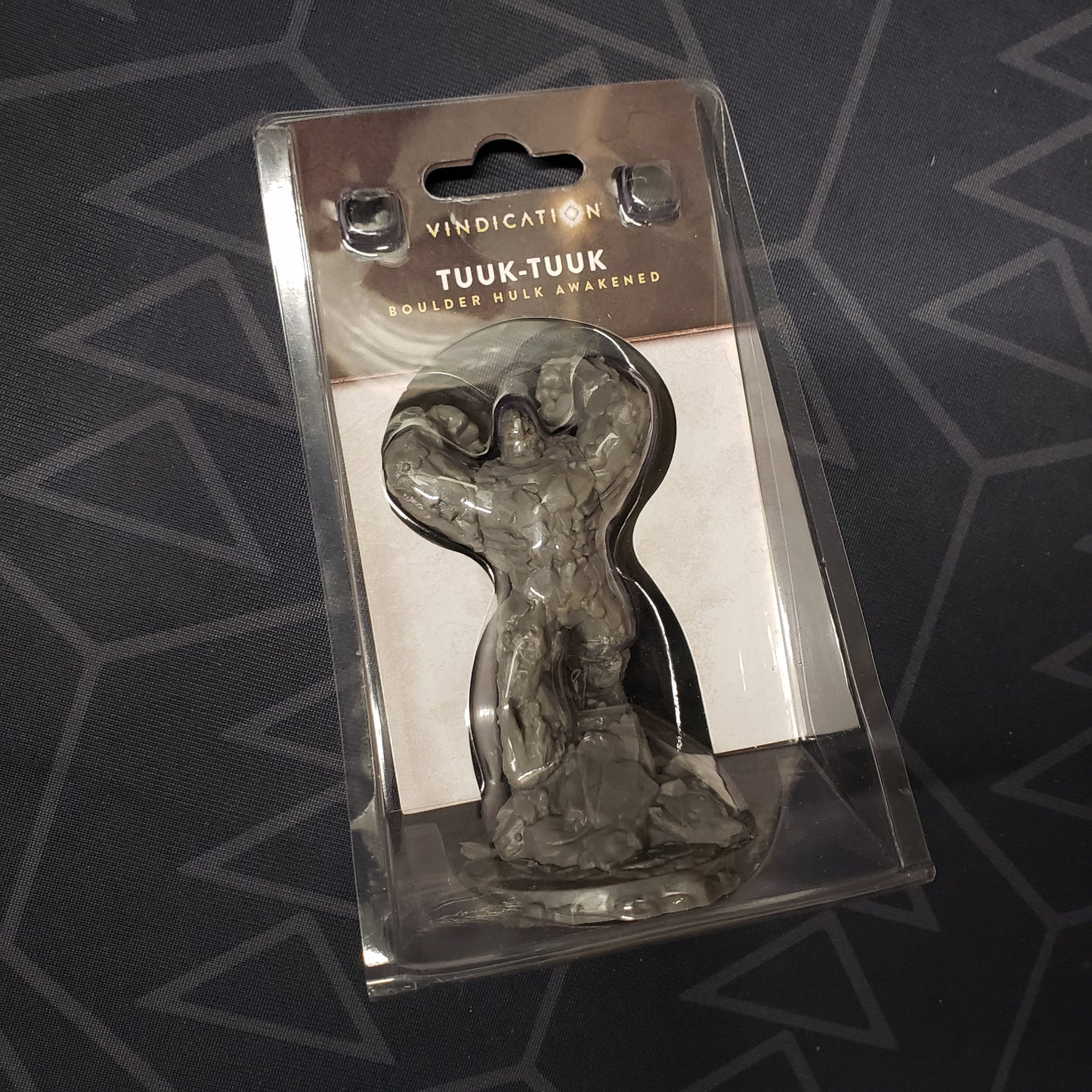 Image shows the front cover of the package of the Tuuk-Tuuk miniature expansion for the board game Vindication