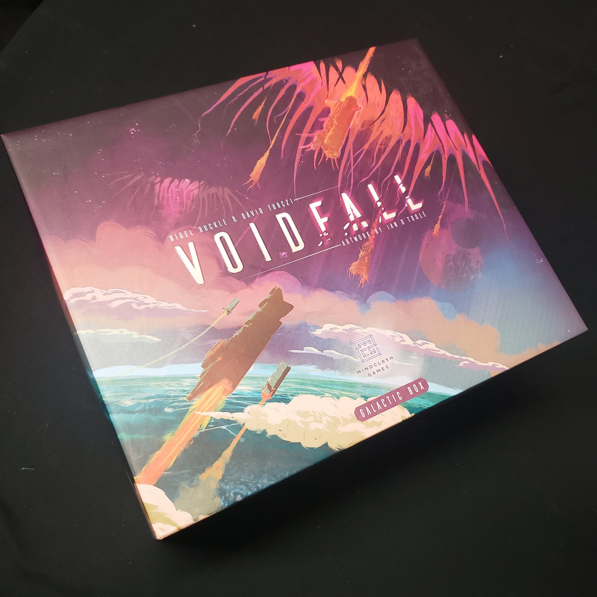 Image shows the front cover of the Galactic Box edition for the board game Voidfall