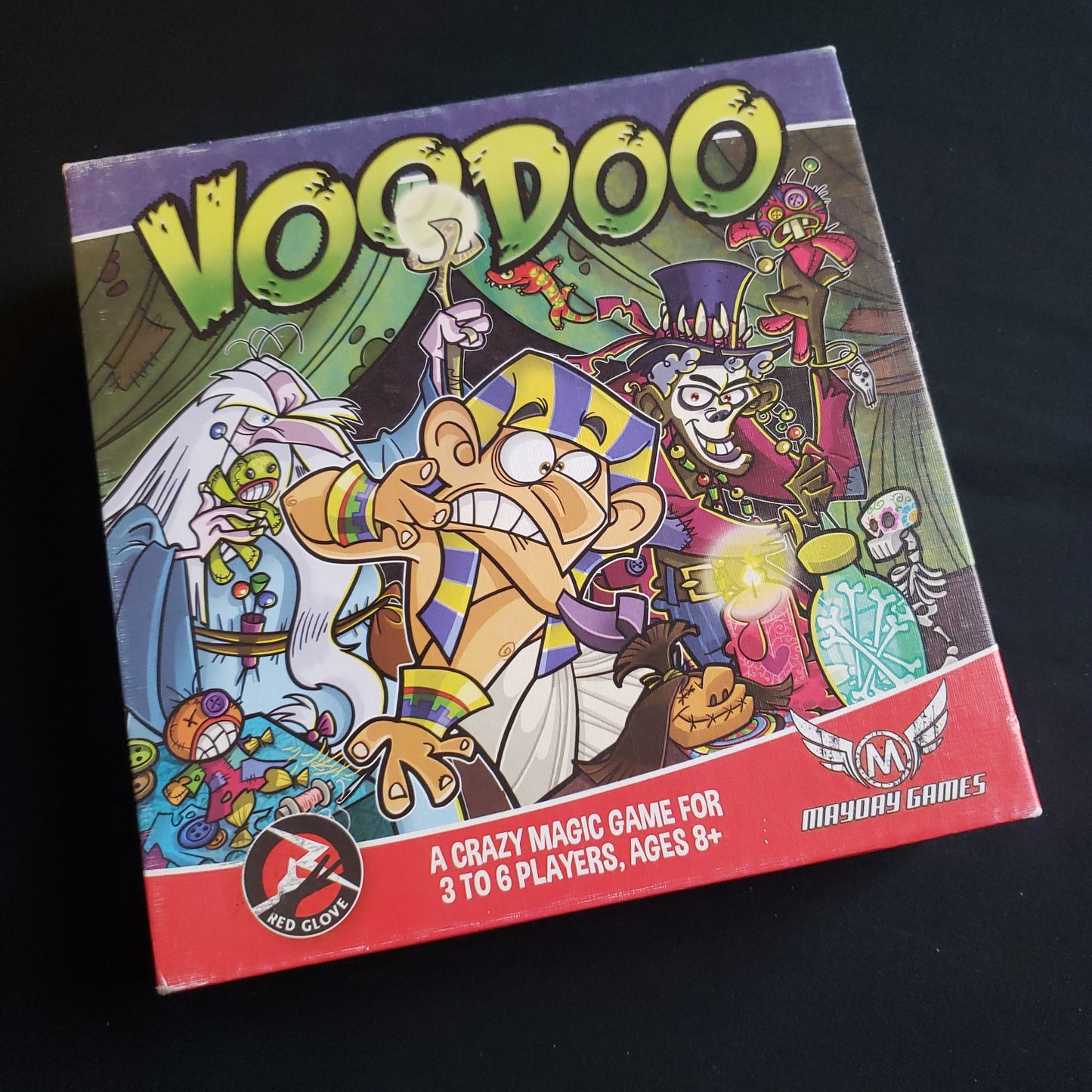 Image shows the front cover of the box of the Voodoo board game