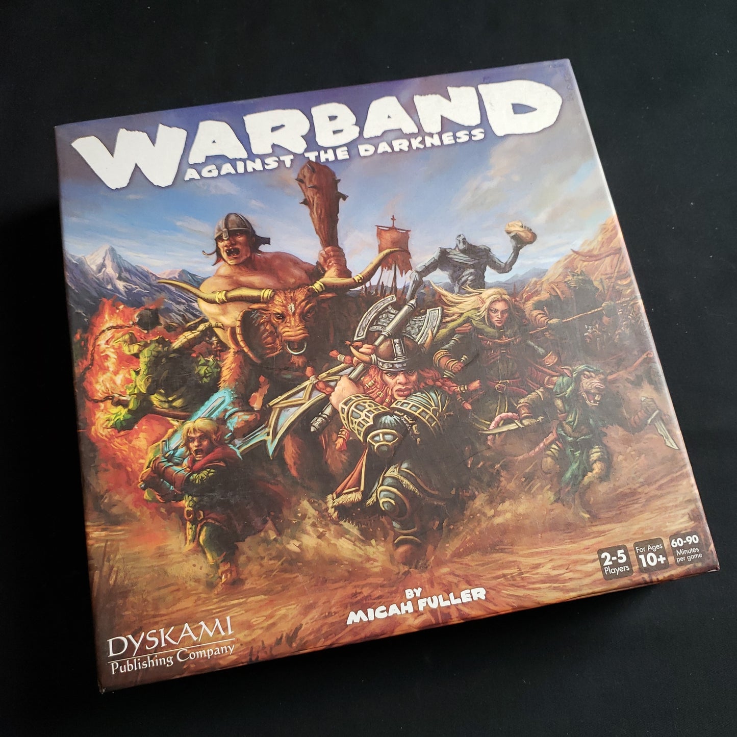 Image shows the front cover of the box of the Warband: Against the Darkness board game