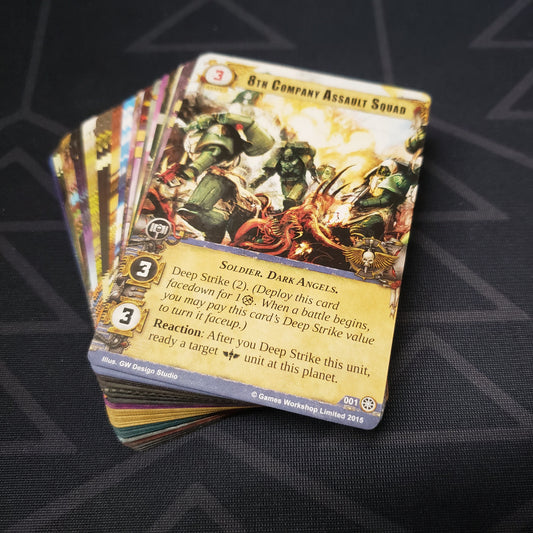Image shows the cards for the Jungles of Nectavus expansion for the card game Warhammer 40K Conquest fanned out in a stack