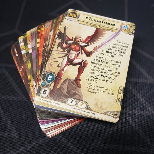 Image shows the cards for the Final Gambit expansion for the card game Warhammer 40K Conquest fanned out in a stack