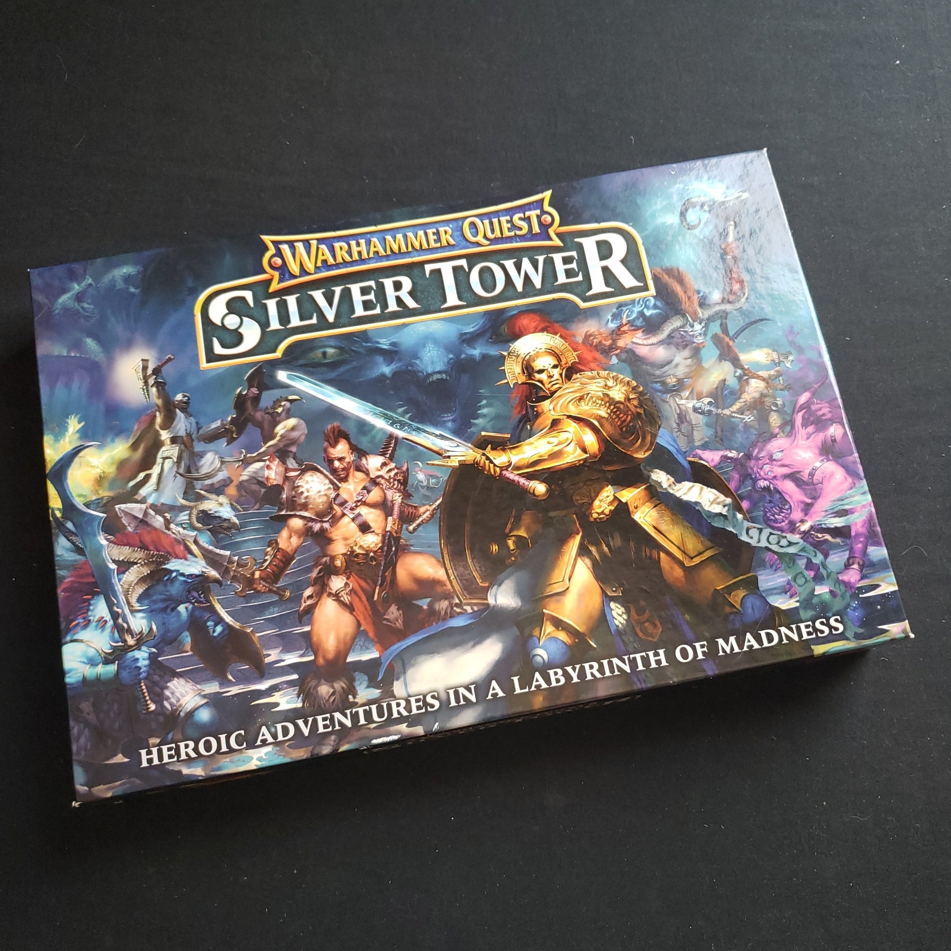 Image shows the front cover of the box of the Warhammer Quest: Silver Tower board game