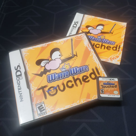 Image shows the case, manual and cartridge for the video game WarioWare: Touched! for Nintendo DS
