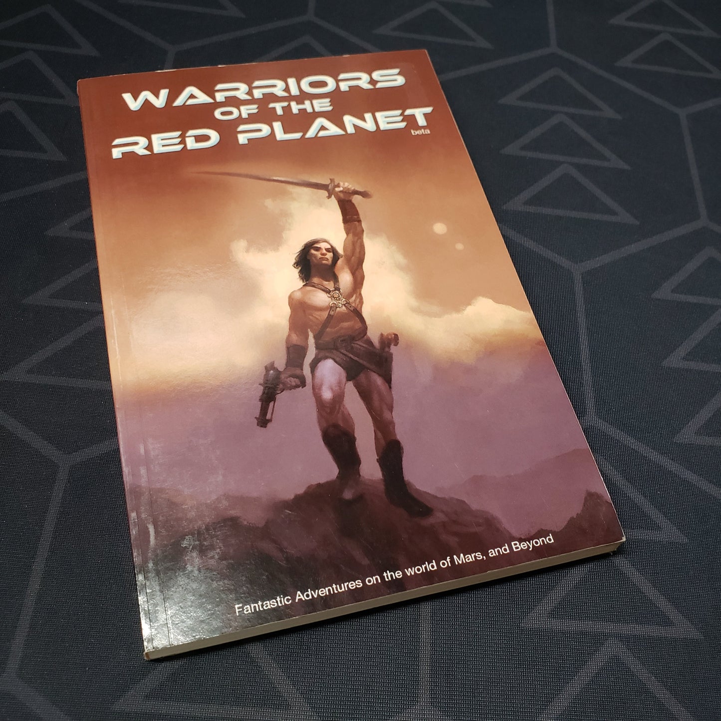 Image shows the front cover of the core rulebook for the roleplaying game Warriors of the Red Planet