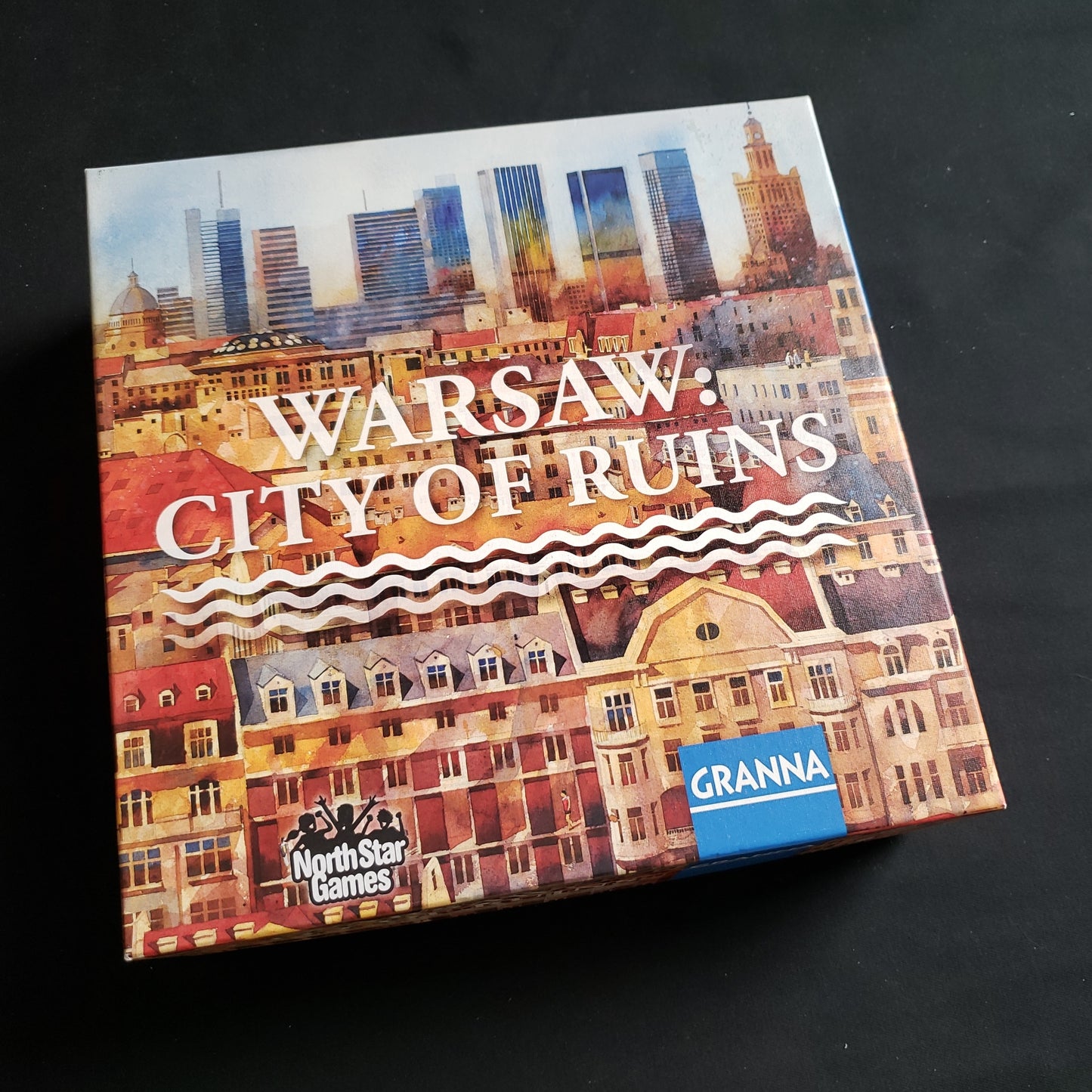 Image shows the front cover of the box of the Warsaw: City of Ruins board game