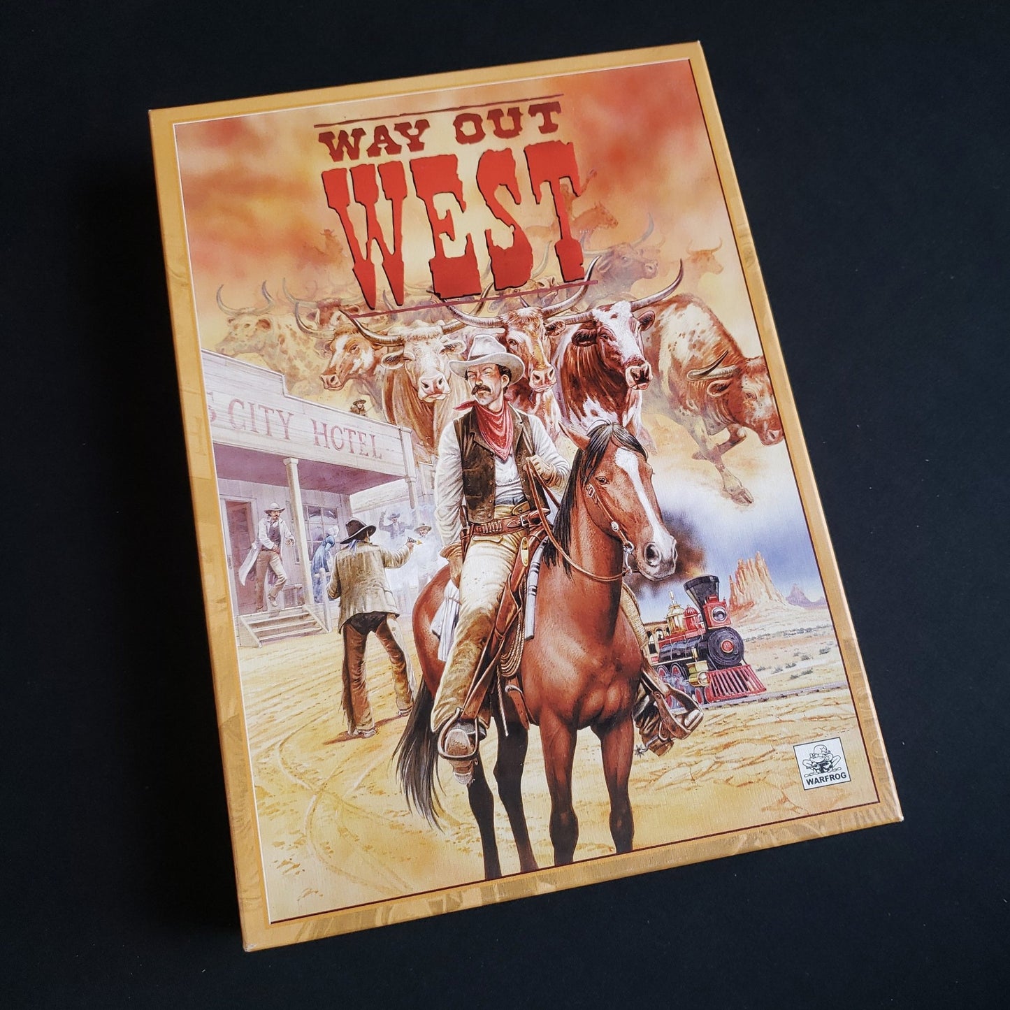 Image shows the front cover of the box of the Way Out West board game