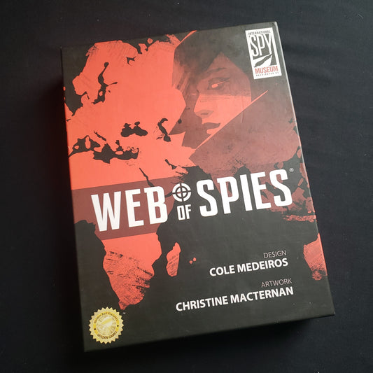 Image shows the front cover of the box of the Web of Spies board game
