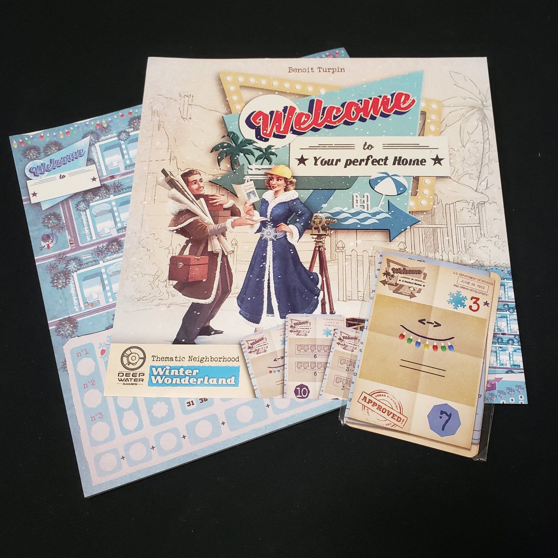 Image shows the score pad, instruction sheet and cards for the Winter Wonderland expansion for the board game Welcome To…