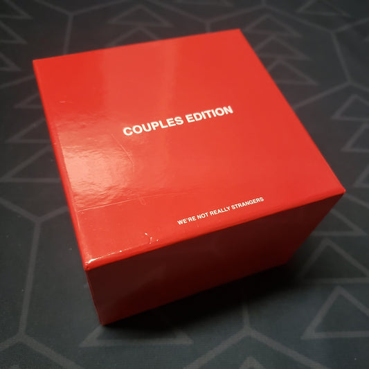 Image shows the front cover of the box for the We're Not Really Strangers (Couples Edition) card game