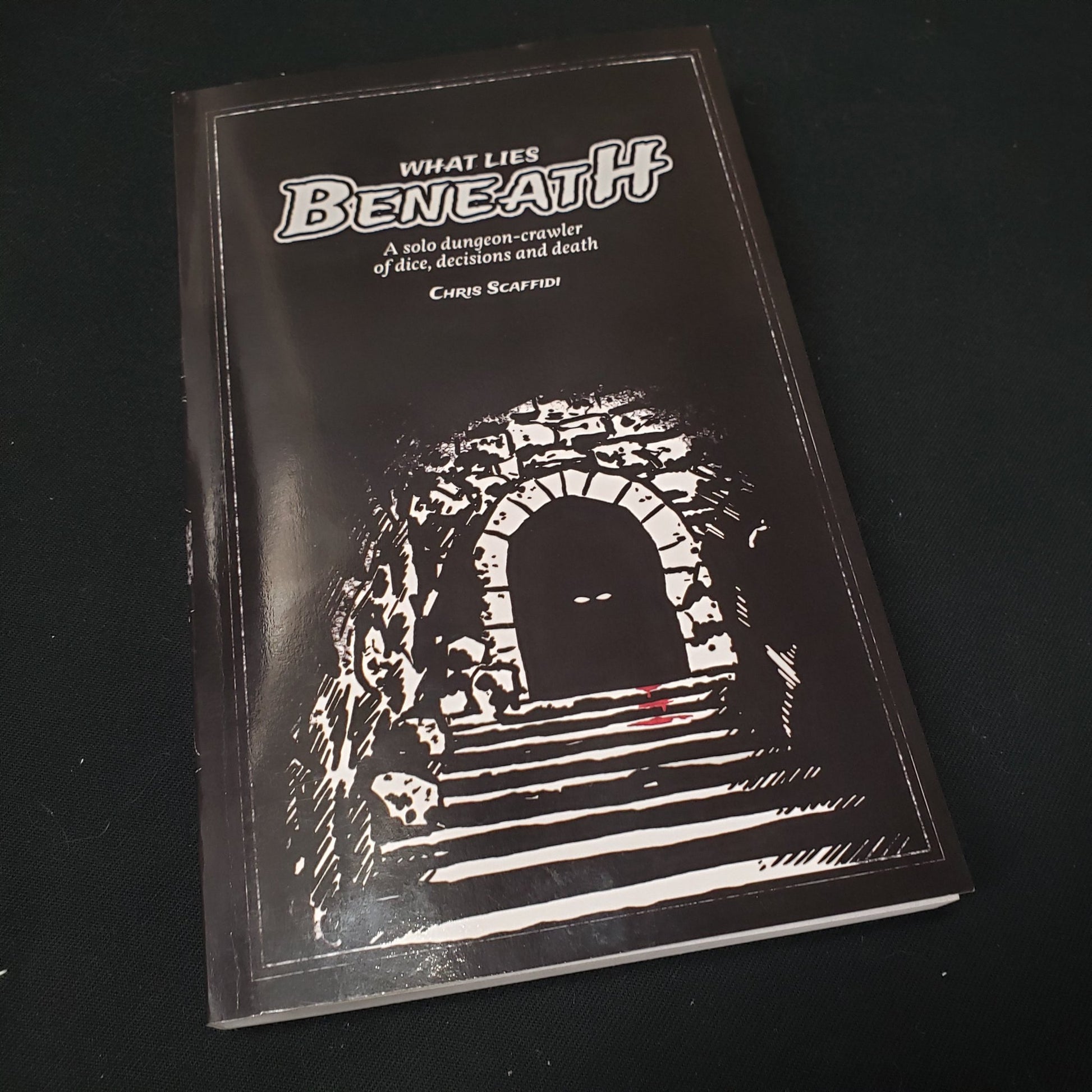 Image shows the front cover of the What Lies Beneath roleplaying game book