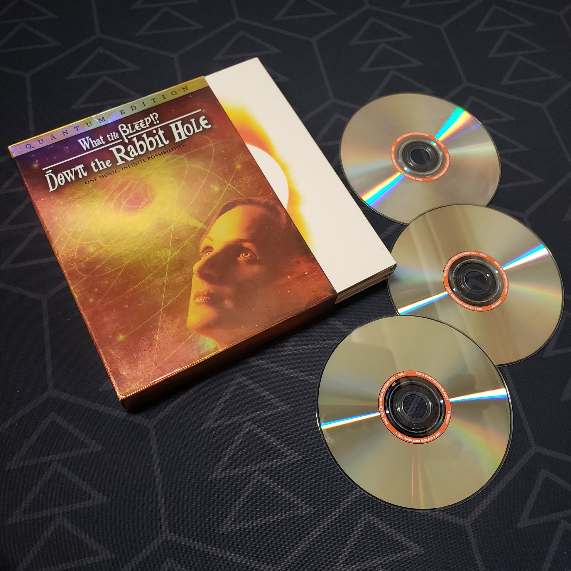 Image shows the case, outer box & three discs for the movie What the Bleep?! Down the Rabbit Hole on DVD