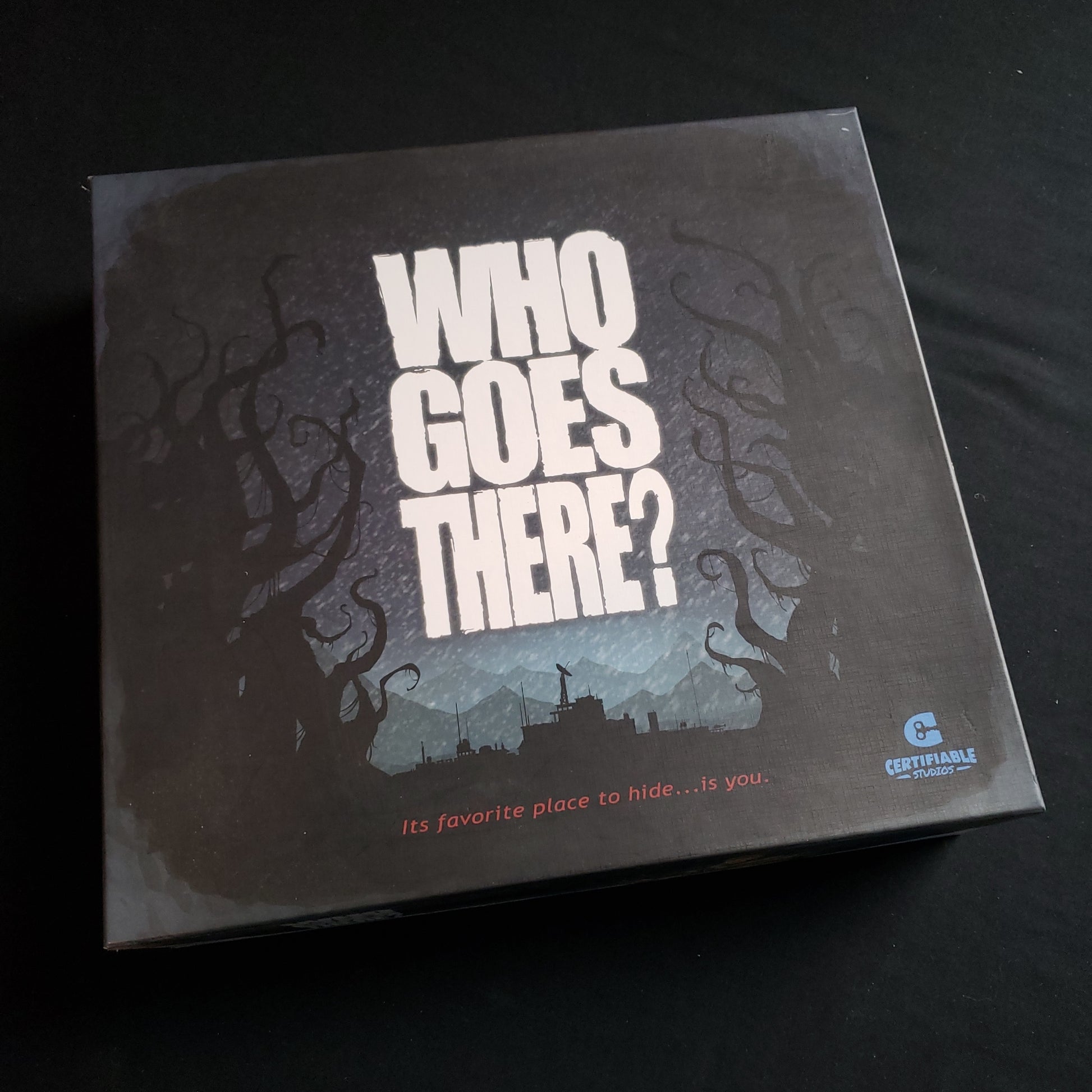 Image shows the front cover of the box of the Who Goes There? board game