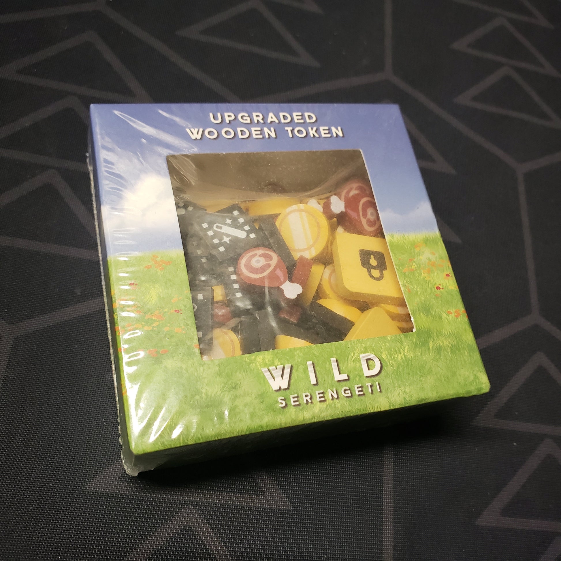 Image shows the front cover of the box for the Upgraded Wooden Tokens pack for the board game Wild: Serengeti