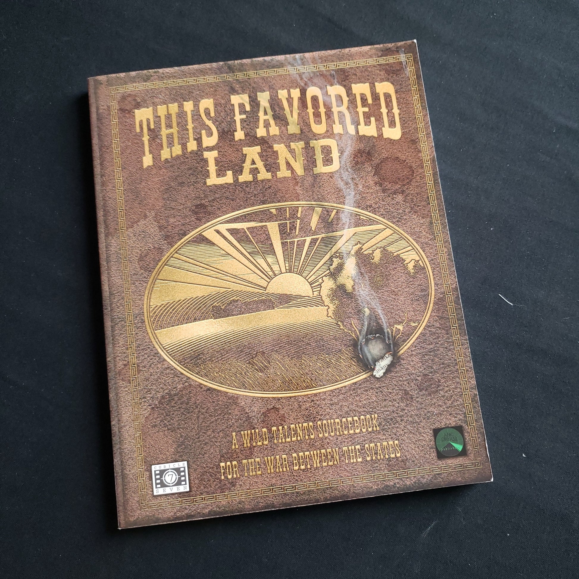 Image shows the front cover of the This Favored Land book for the Wild Talents roleplaying game