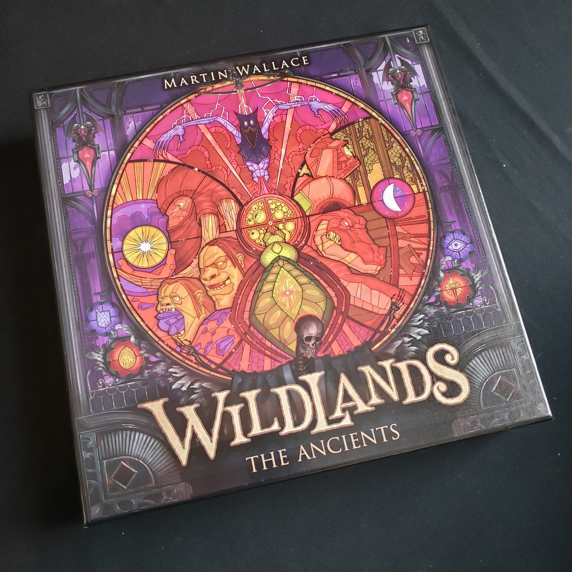 Image shows the front cover of the box of the Ancients expansion for the board game Wildlands