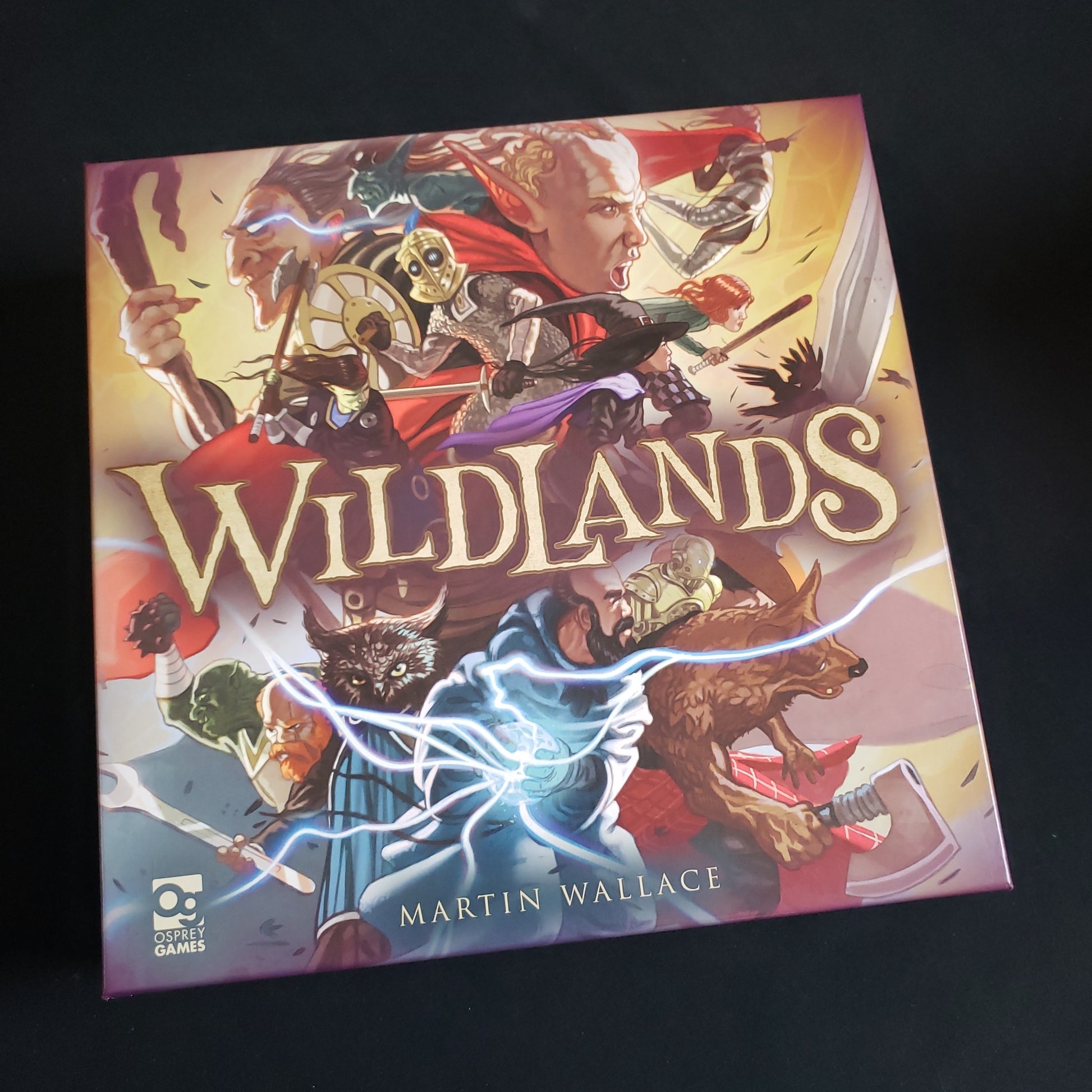 Image shows the front cover of the box of the Wildlands board game