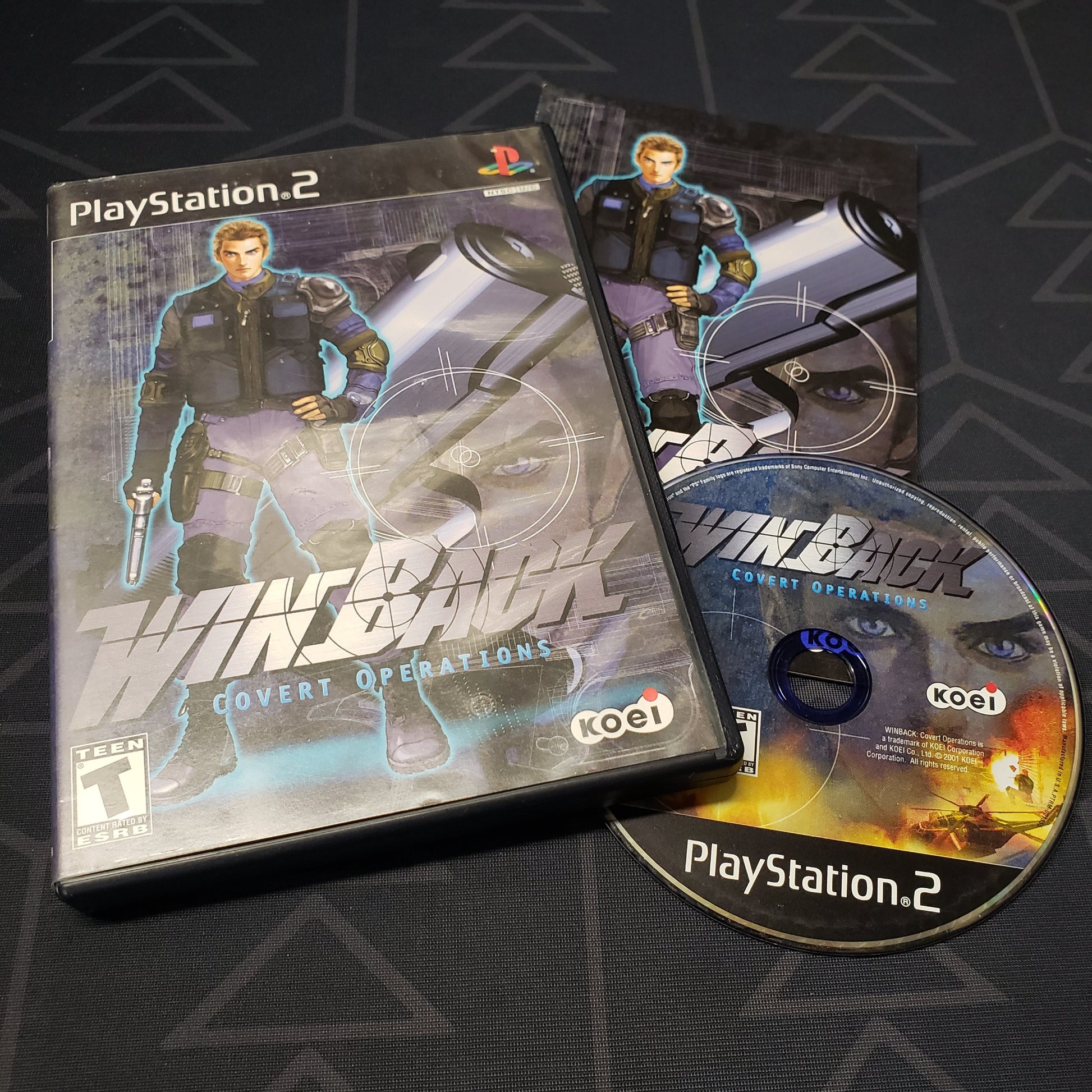 Image shows the case, manual and disc for the video game Winback: Covert Operations for Playstation 2