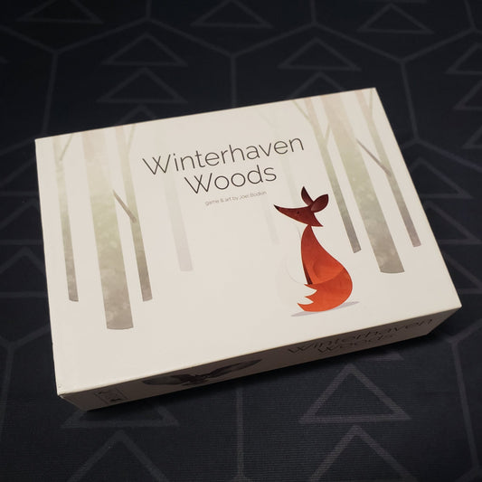 Image shows the front cover of the box of the Winterhaven Woods card game