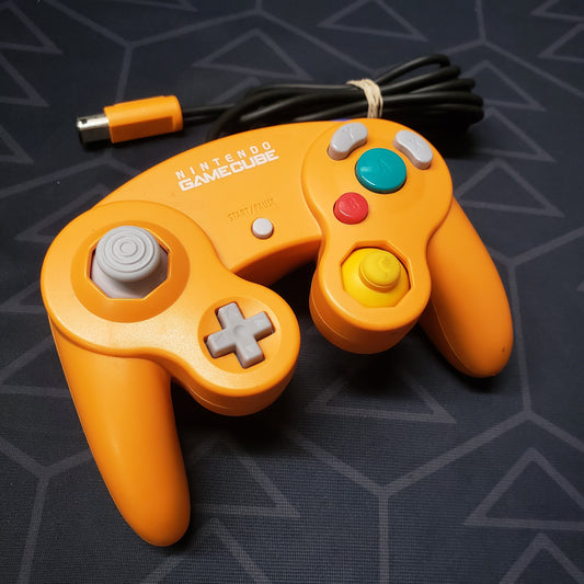 Image shows a wired orange gaming controller for the Nintendo Gamecube