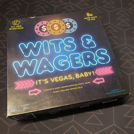 Image shows the front cover of the box of the Wits & Wagers: It's Vegas, Baby! board game
