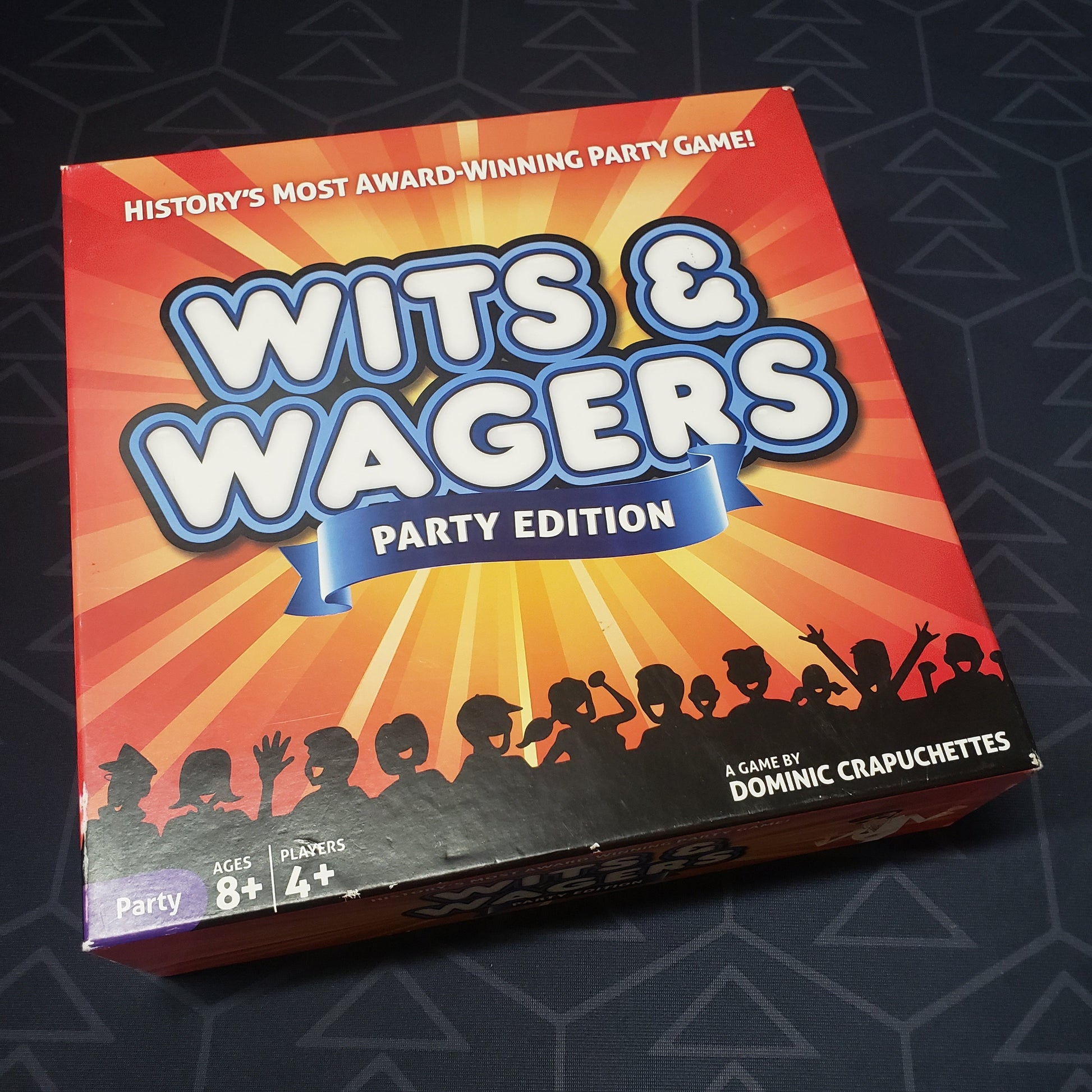 Image shows the front cover of the box for the Wits & Wagers: Party Edition card game