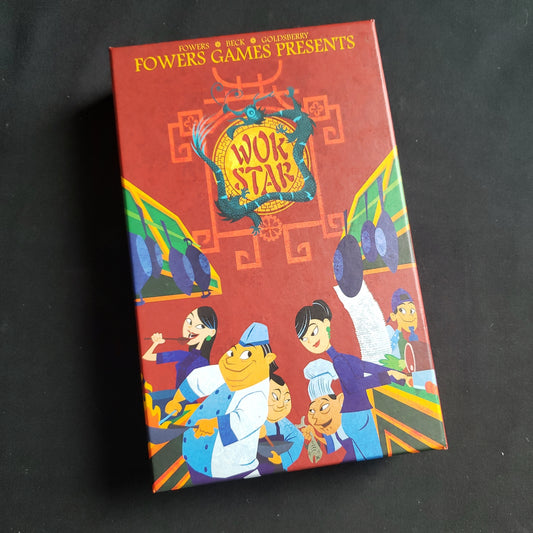 Image shows the front cover of the box of the Wok Star board game