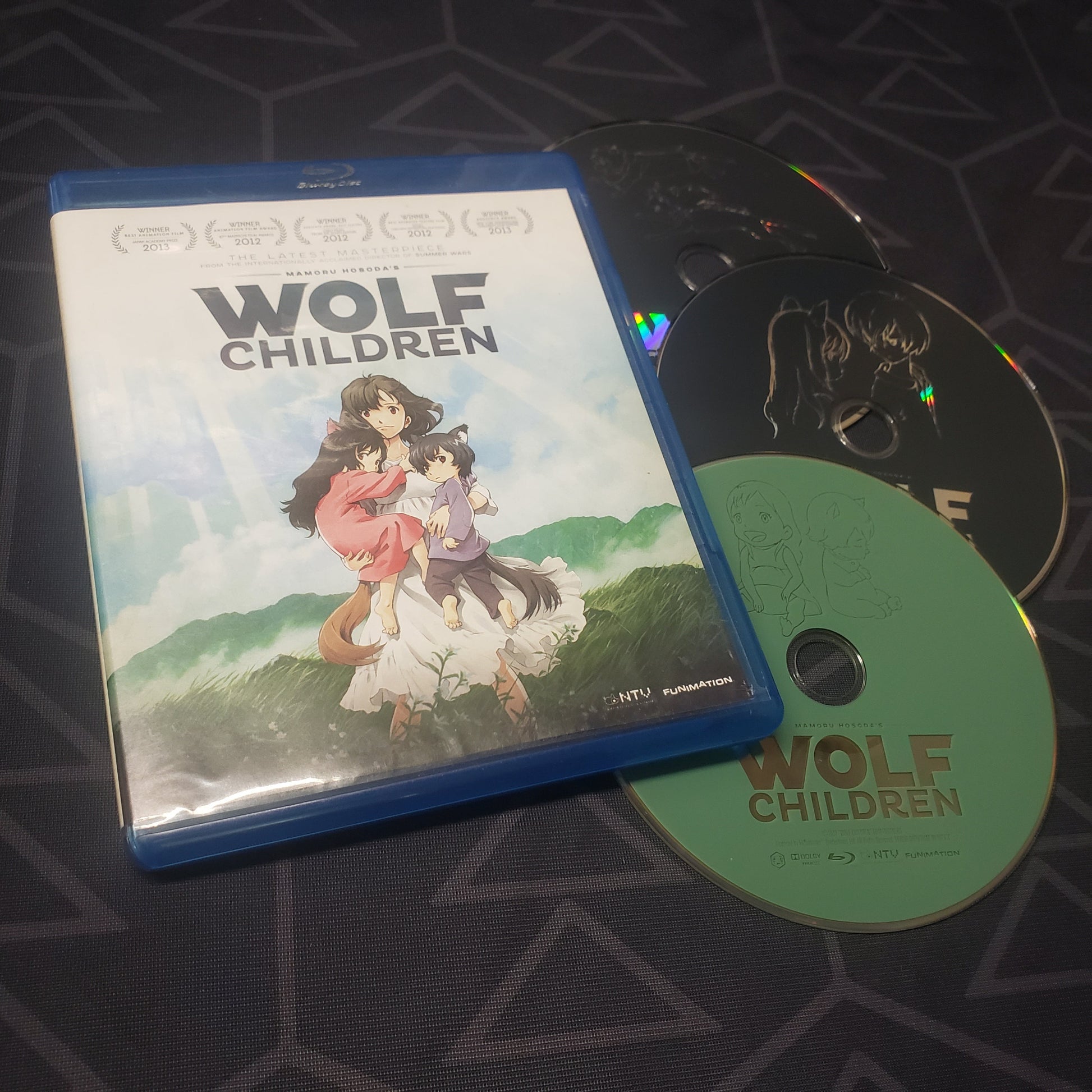 Image shows the case & three discs for the movie Wolf Children on Blu-Ray + DVD