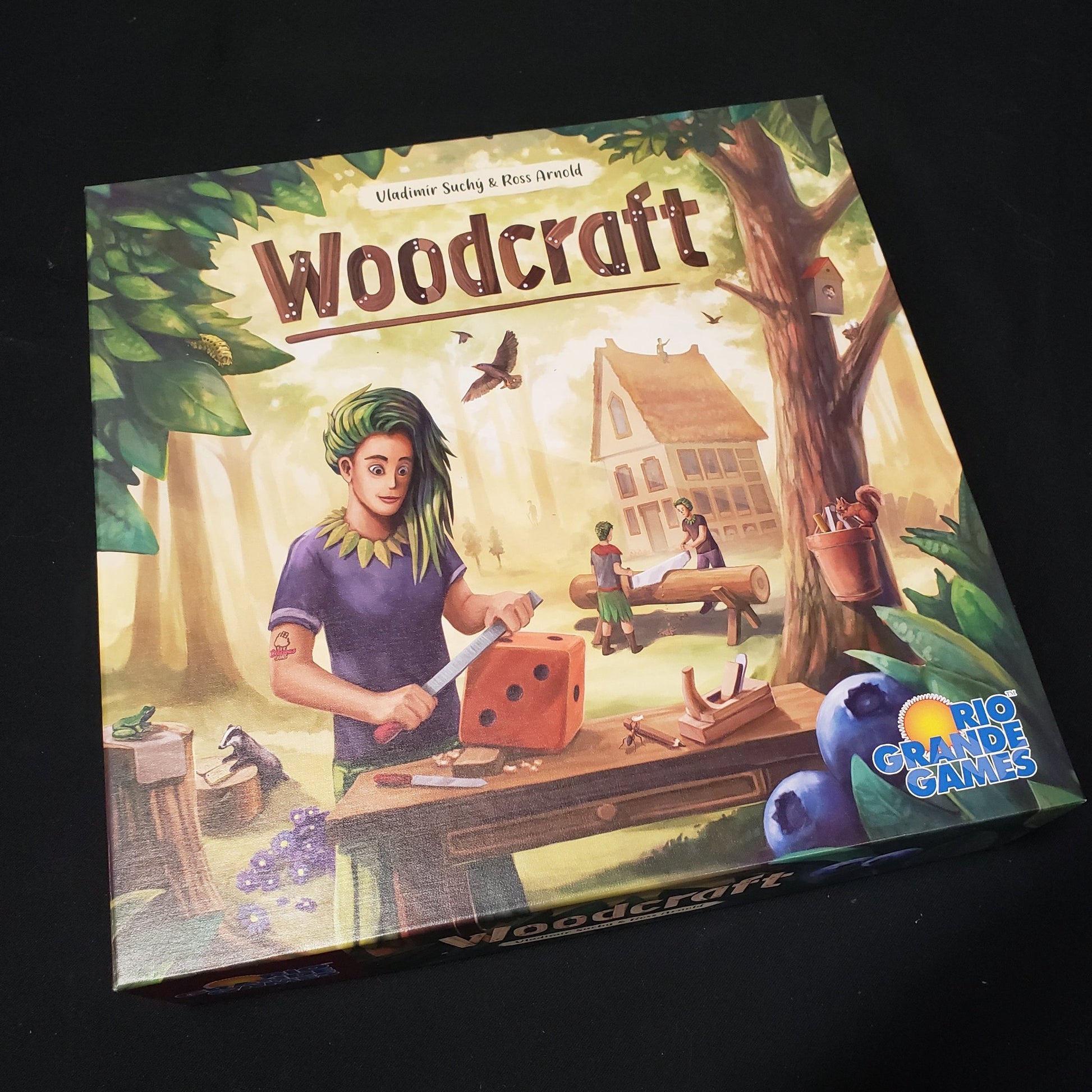 Image shows the front cover of the box of the Woodcraft board game