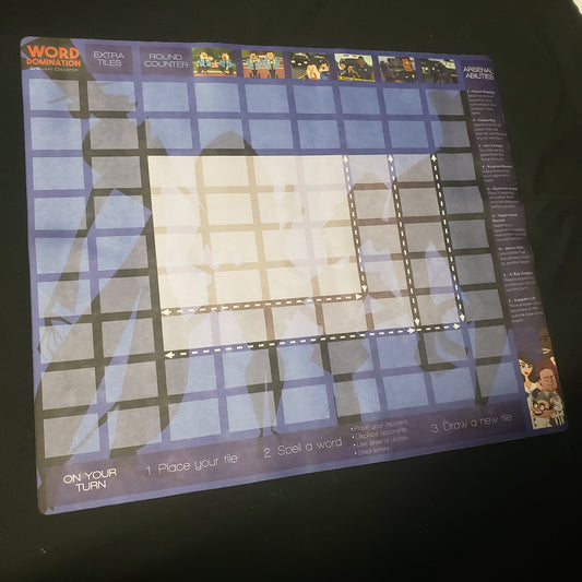 Image shows a multiplayer gaming playmat for the card game Word Domination