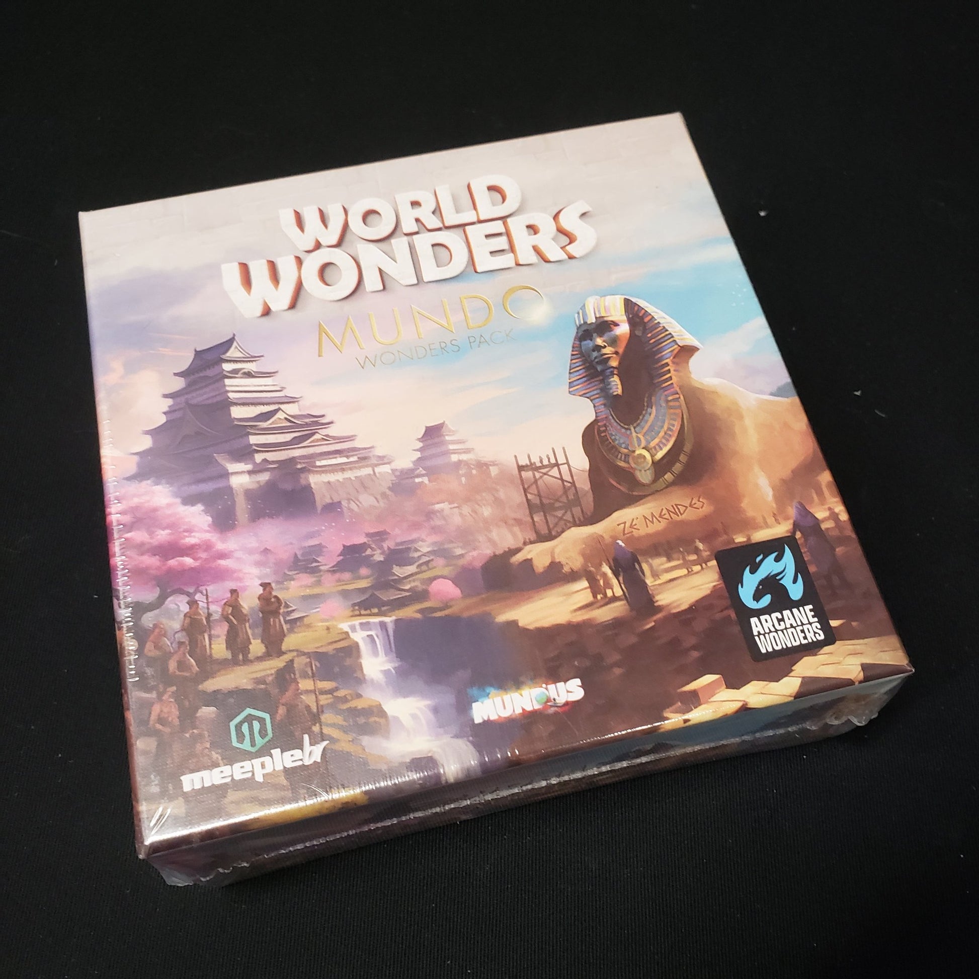 Image shows the front cover of the box of the Mundo Wonders Pack expansion for the board game World Wonders
