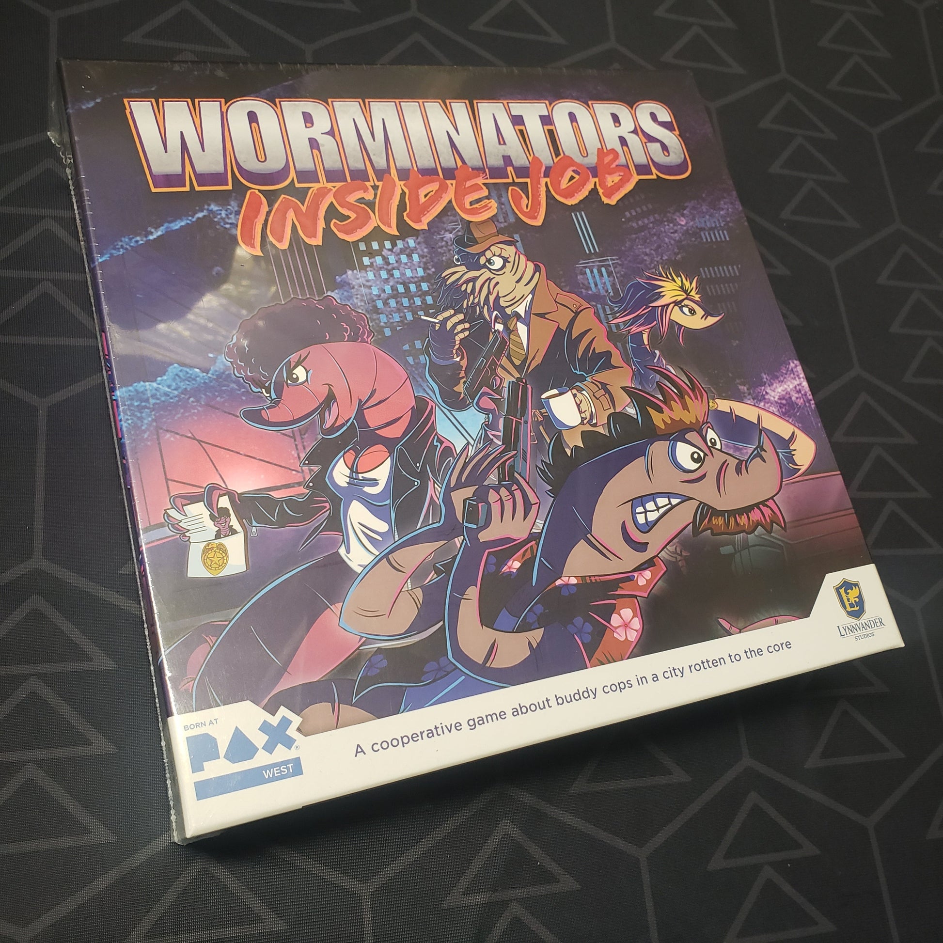Image shows the front cover of the box for the Worminators: Inside Job board game
