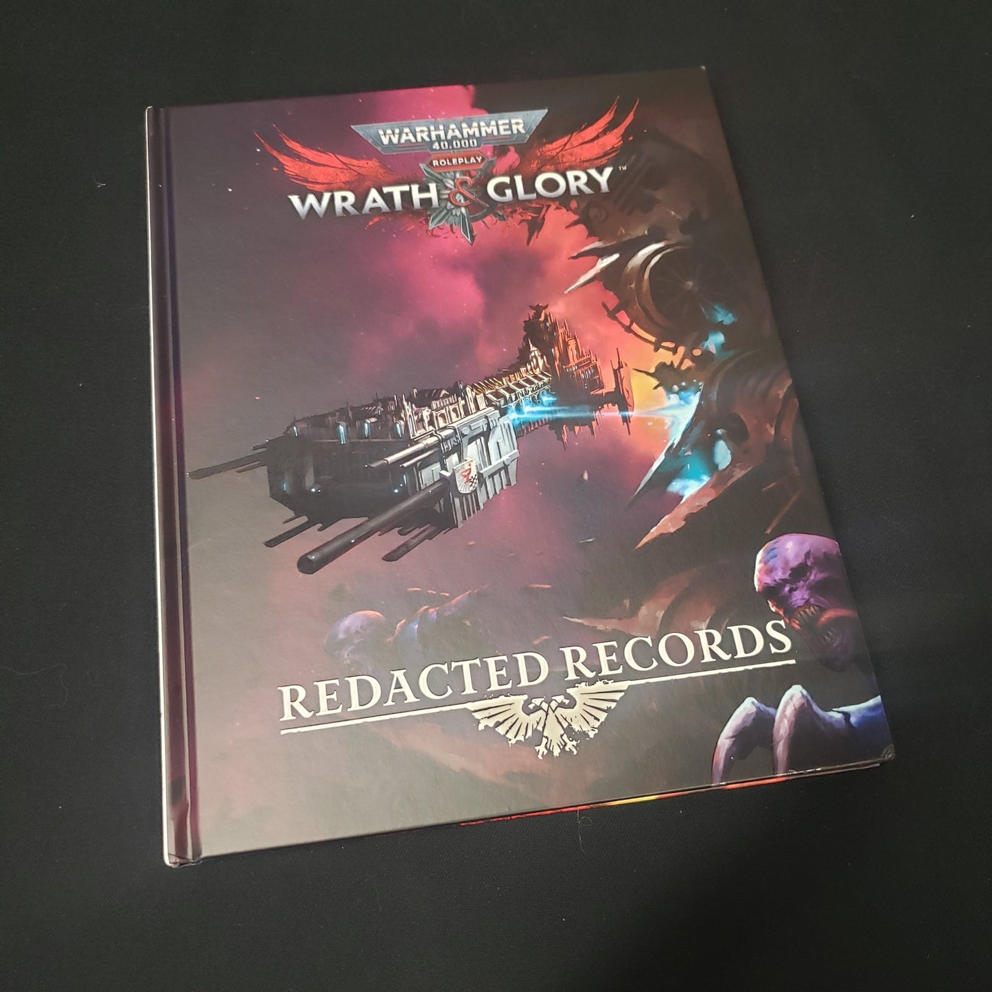 Image shows the front cover of the Redacted Records book for the roleplaying game Wrath & Glory
