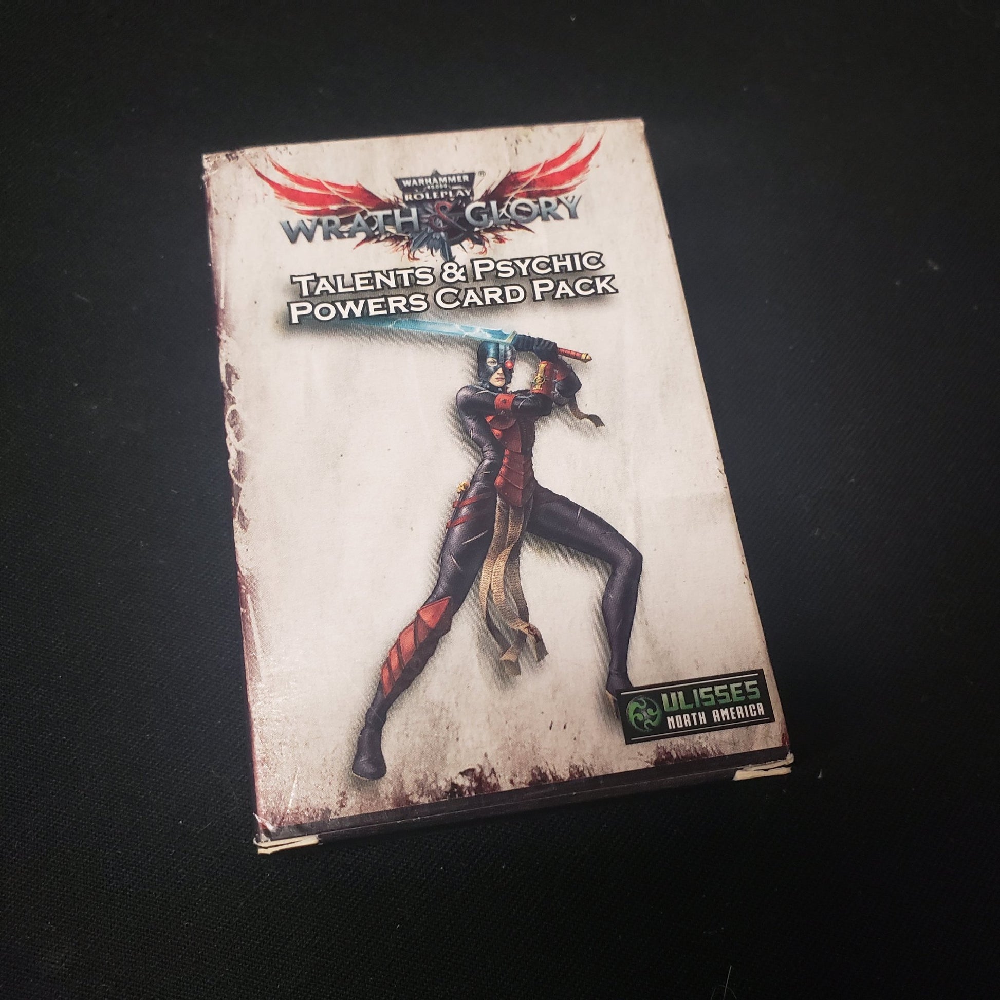 Image shows the front cover of the  package of the Talents & Psychic Powers Card Pack for the roleplaying game Wrath & Glory