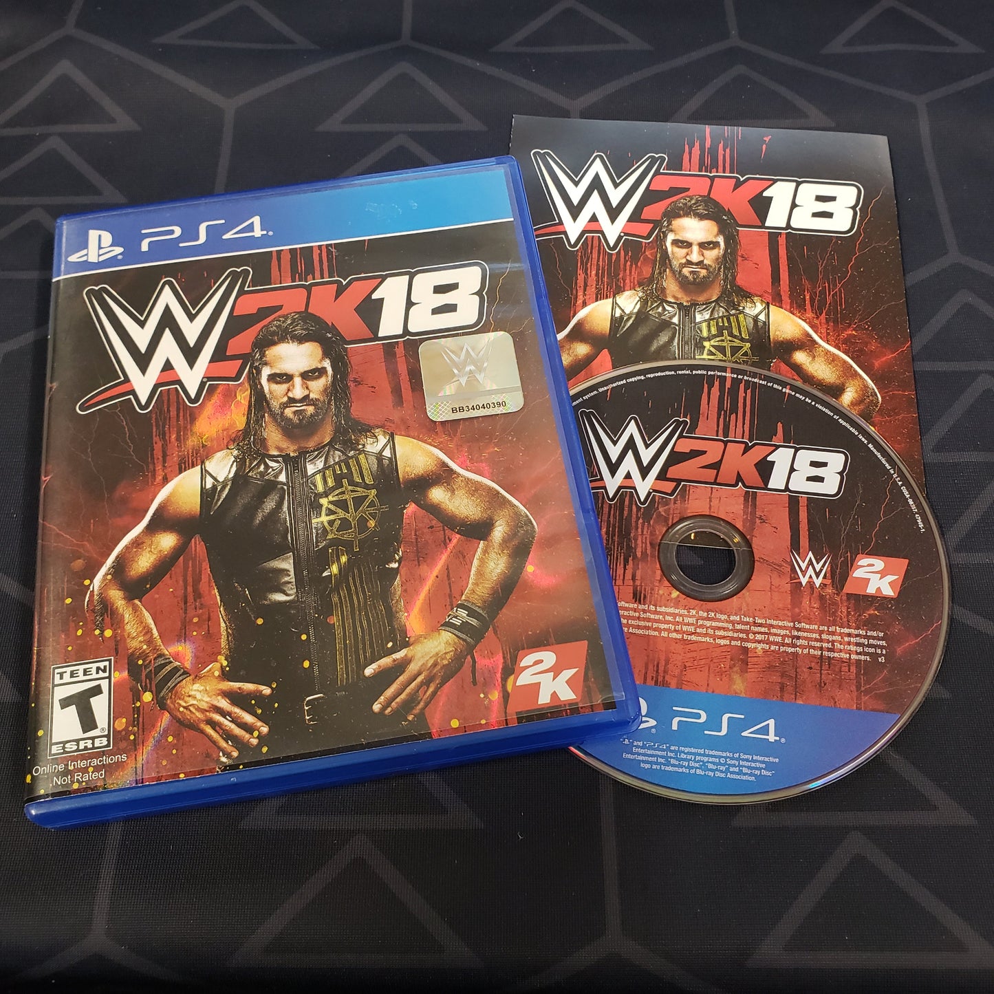 Image shows the case, manual and disc for the video game WWE 2K18 for Playstation 4