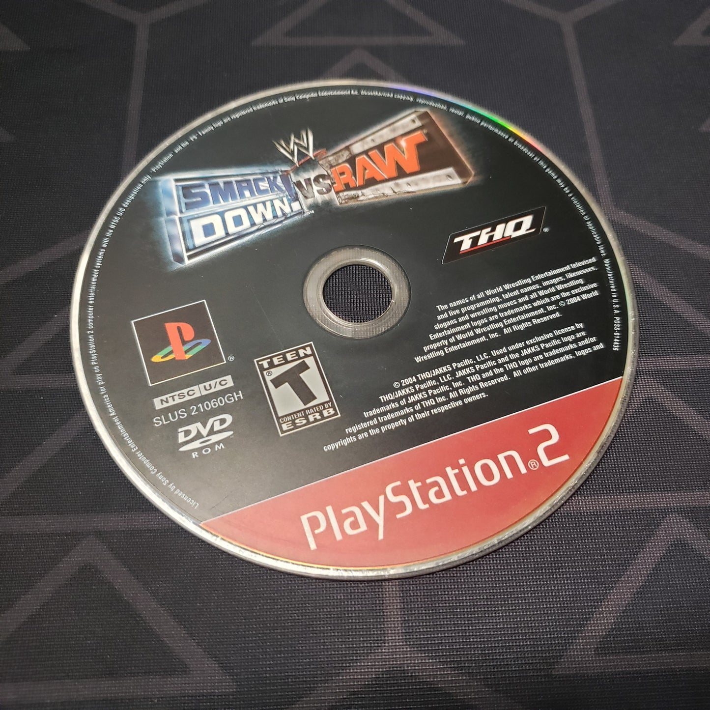 Image shows the label side of the game disc for the video game WWE Smackdown vs. Raw for Playstation 2
